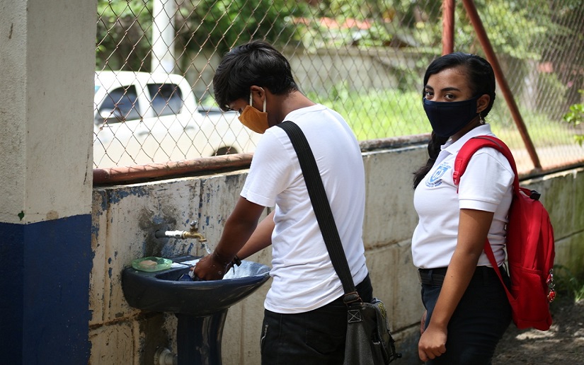 Students are required to wash hands before entering classrooms. Photo credit: El19Digital